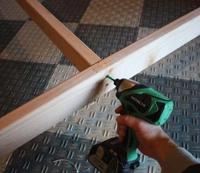 Screw the cross-members through the bed rails and into the end grain.