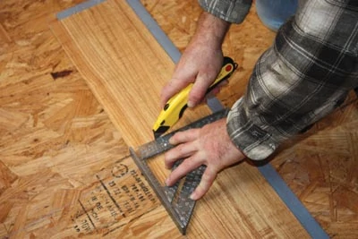 Vinyl planks can easily be cut with a Speed Square and utility knife.