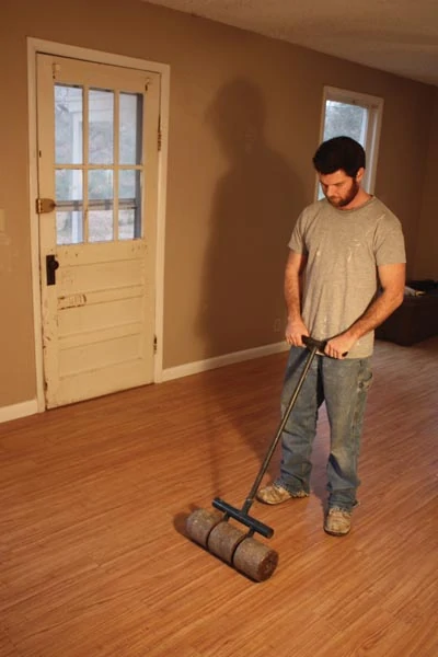Once the floor is complete, roll the entire installation with a floor roller.
