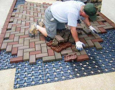 AZEK pavers weigh much less than concrete and install on a grid. 