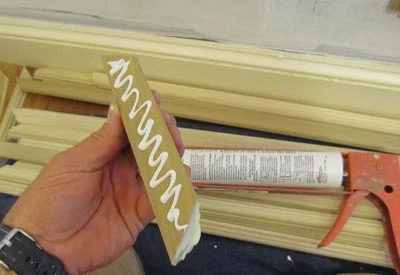 The molding installed with a combination of adhesive and finish nails. For wood molding we used latex adhesive caulk. For the flexible molding we used polyurethane construction adhesive.