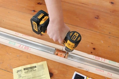 Installing a pocket door is one of those projects where you need your DIY mojo of knowing how to solve problems. But you also need to read the instructions for the hardware you’re installing. We used a kit from Johnson Hardware.