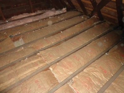 Wrong, wrong, wrong. This photo shows how fiberglass insulation was improperly installed in an attic with the paper facing away from the living space. 