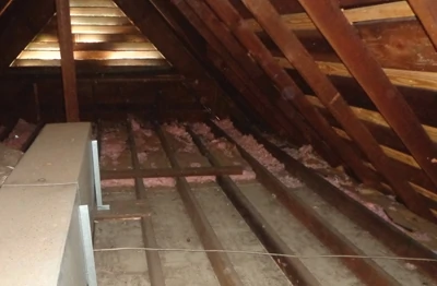 Insulation should be installed in the bare attic joist bays with the paper facing toward the living space.