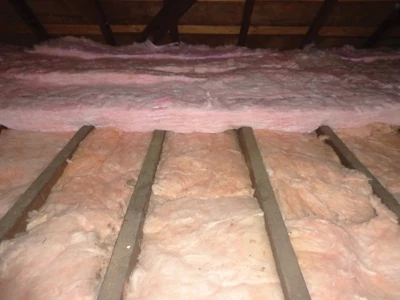 When installed perpendicular to the faced fiberglass insulation, the additional layer of unfaced rolled insulation provides extra R value while also insulating the wood framing members, which don’t otherwise provide a very effective thermal break. 