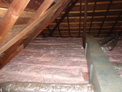 Here’s the completed attic with the new fiberglass insulation completely installed for a combined R-value of 49. 