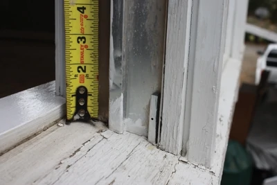 Measure the height of windows from the sill to the top jamb. The sill is usually sloped to shed water away from the house, so it’s important to take the measurement from the uppermost point of the sill. 