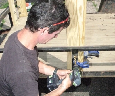 Clamp the stave square to the trailer frame and drill the hole for the through-bolt. 