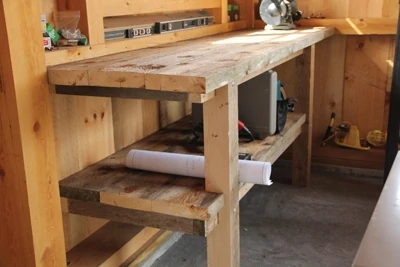 This rustic wooden bench was built from rough-sawn 2x10 planking and 4x4 stock. 