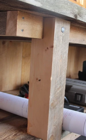 Note that the legs are notched to carry the weight of the support frames of the shelf 