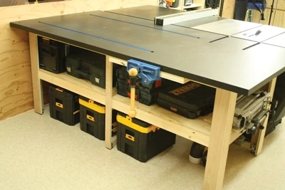 This photo shows the assembly table being used as an outfeed bench for a table saw, while providing ample tool storage. 