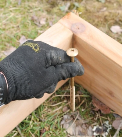Use screws stuck through a piece of tape to mark the centers of the post holes. 
