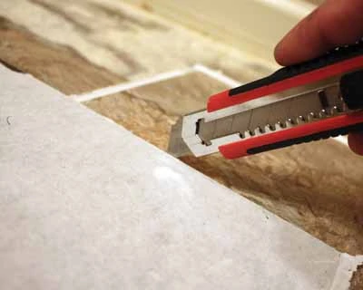 Vinyl tiles can easily be cut with a utility knife and a straight edge. 