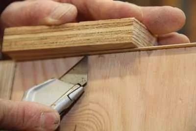 Use a table surface or a wood block as solid backing when trimming the tape. 