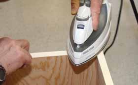 Once the tape is in position, heat it with an iron to activate the adhesive. 