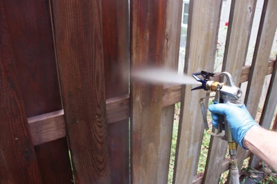 To minimize runs and overspray, keep the sprayer nozzle 10” to 12” away from the surface when applying the stain. 
