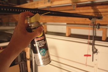 Lubrication prevents corrosion of metal garage doors and allows the moving components to move more quietly and smoothly with less wear from friction. Lubricate the chain drive (or screw drive) with white lithium grease, available at any home center. You can coat overhead torsion springs or extension springs with standard WD-40.
