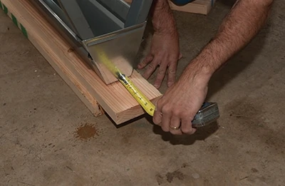 The 2x6’s we add to the tops of folding saw horses are a few inches longer than the horses for added material stacking. 