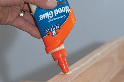 Apply wood glue to the non-chamfered edge of the 2x4’s. 