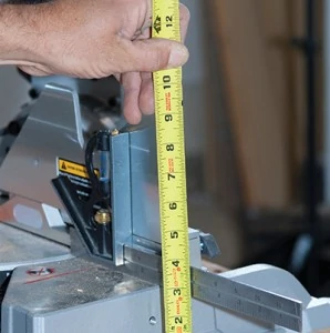 Place a wing board on the table next to the saw base and measure from the wing board to the saw surface to determine the height of the wing-board support blocks. 