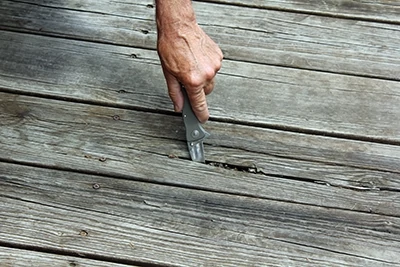 Many old boards had wide cracks and splinters. The first step was to test for any soft rotten spots. 