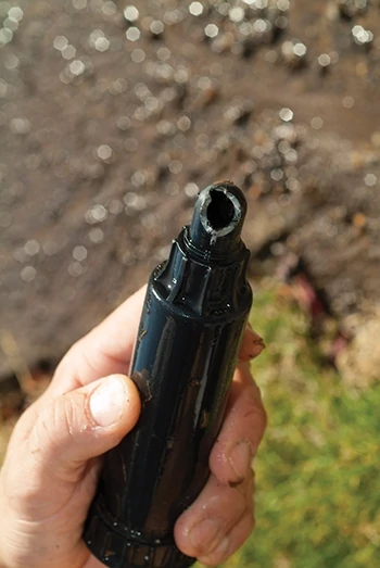 By pulling up the pop-up sprinkler head, we could see that the elbow fitting that connected the sprinkler head to the flexible pipe was broken at the turn in the elbow. 