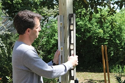 When installing the posts, check each side with two hand levels (or a post level) to ensure plumb alignment. 