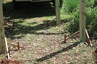 Brace the posts from each side to hold them in position while you pour the concrete footings.