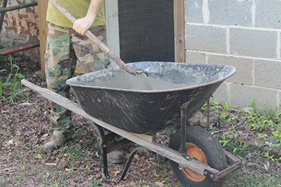Ready-mix concrete is easy to mix with water in a wheelbarrow using a shovel.