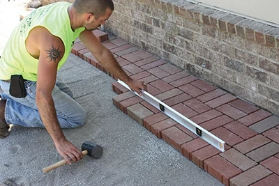 Continuously level the pavers during installation to maintain a flat walking surface and eliminate high spots. 