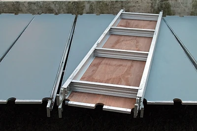 Scaffolding walk boards are built with aluminum frames and engineered not to flex, providing a stable surface for construction work. 