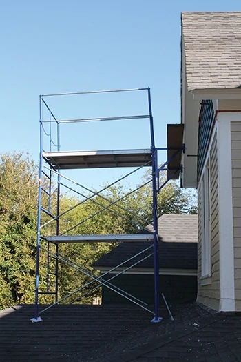 Scaffolding can be set up on the ground level or on a lower roof. 