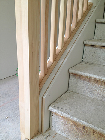 Notice that the stair skirt covers the drywall at the inside of the staircase and is fit to a ¼” reveal on the knee wall cap. 