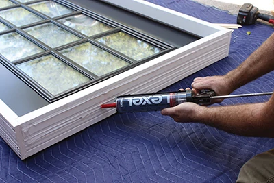 Liberally apply beads of high-quality sealant to the joint between jambs. 