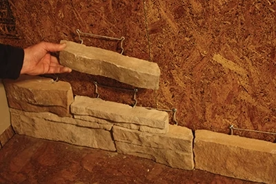 Stagger joints from row to row. Some stones are half the height of others and require two stones to be stacked together .