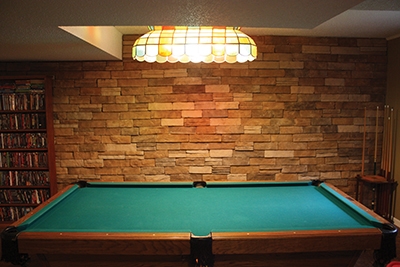 The completed veneer gives the basement a warm, rustic feel and greatly enhances the look of the room.