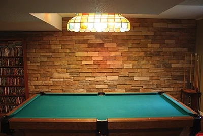 The completed veneer gives the basement a warm, rustic feel and greatly enhances the look of the room. 