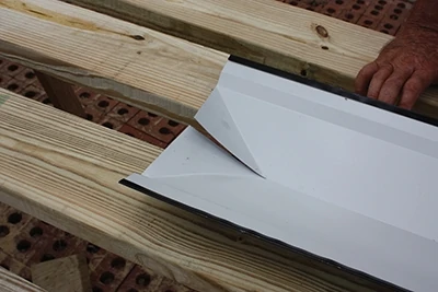 The folded ends of the ridge cap will conceal the corners of the roof for a more finished appearance.