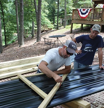 This crew builds a lot hip roofs to a common pitch, and they made a wood jig to guide the matching panel’s cuts. 