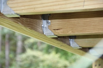 Use metal joist hangers to connect all joist ends. 