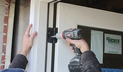 Refer to the manufacturer's instructions for specific steps to install your door. They often come with ong hinge screws that are driven through the hinge locations of the jamb, through shims and into the stud framing. Make sure not to bow the sides of the door frame. 