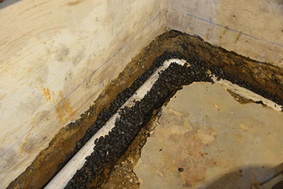 A perimeter drain is an amazingly simple thing disguised in massive amounts of work. If your basement is even a little wet, you probably need one. 