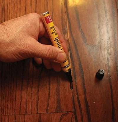 A wood stain marker is an easy way to conceal scratches in furniture and hardwood flooring. 
