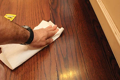 Simply apply a matching stain to the scratch and wipe away the excess to make little dings "disappear."