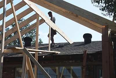 The new ridge will tie into the existing roof as a hip-and-valley offshoot. 