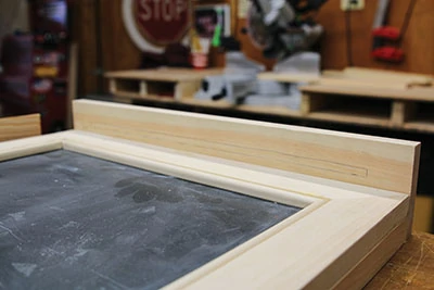 Align the chalkboard shelf and mark the position of the chalk slot. 