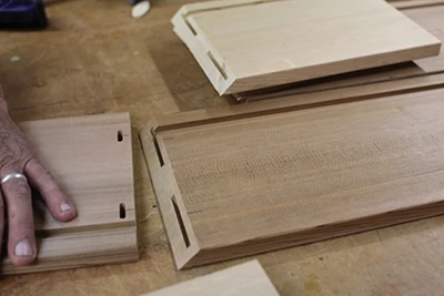The slots in the corners hold wood biscuits to strengthen the joints. 