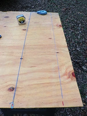 Snap a chalk line between the upper marks and a second parallel line between the lower marks. 