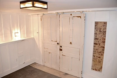 Reclaimed doors and Johnson rolling door hardware combine for a look that works great and is easy to install.