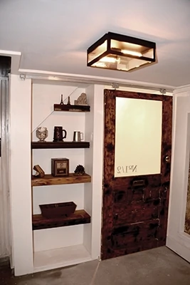 Frosted glass (Krylon frosted glass spray) and reclaimed lumber rock this cubby under the stairs.
